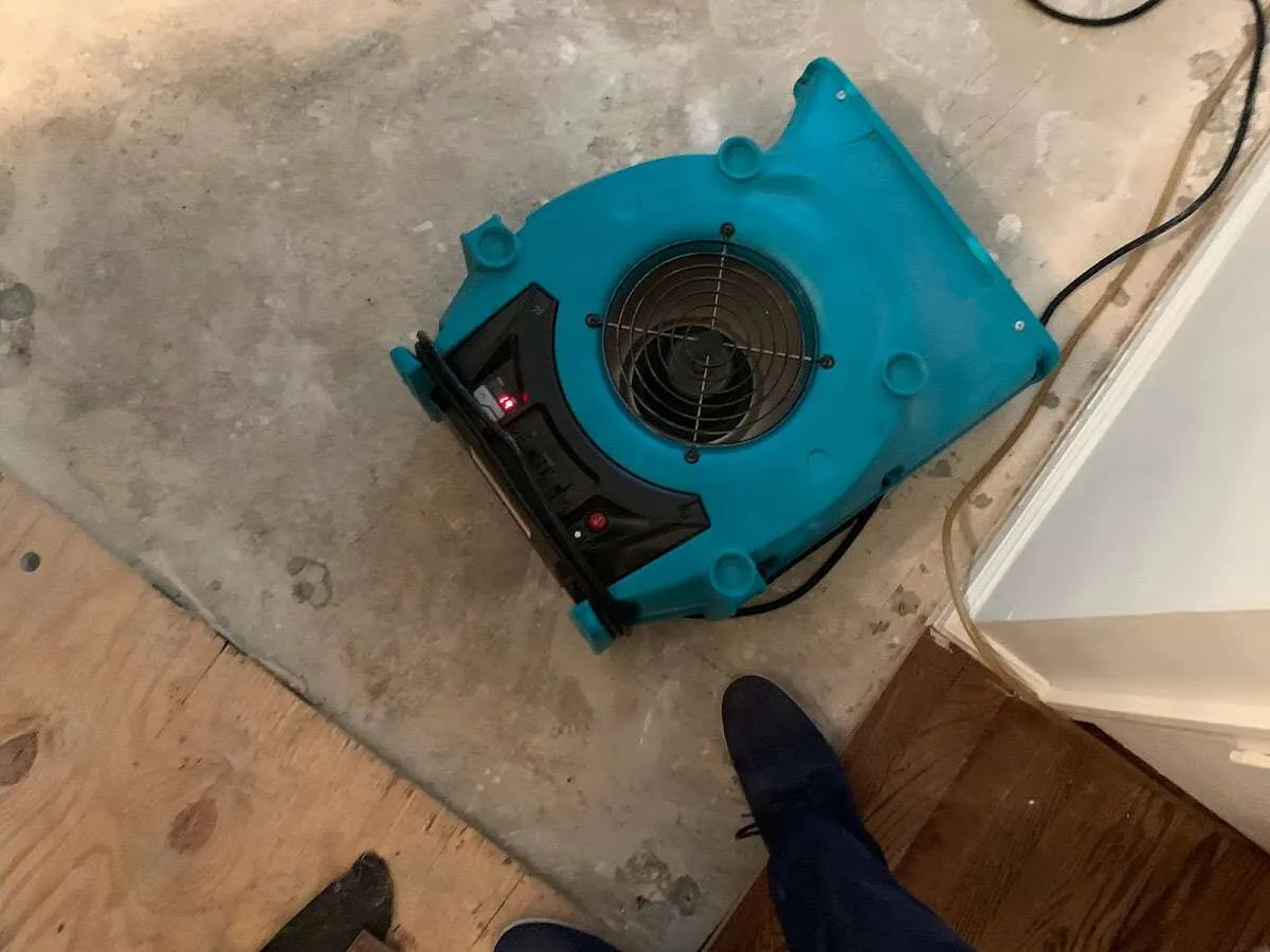 Air mover drying subfloor during Leak Detection & Repair in East Chicago